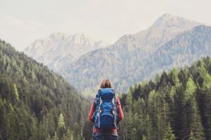 A hiker looking trees and mountains A hiker looking trees and mountains
